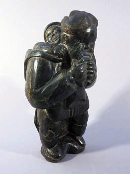 Work: Mother chewing on a kamik with child in her amaut