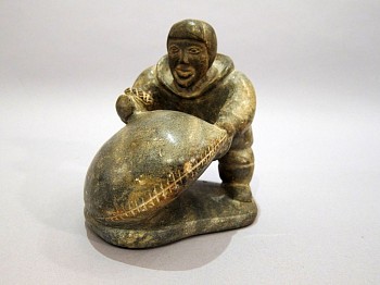 Work: Hunter filling a seal bladder